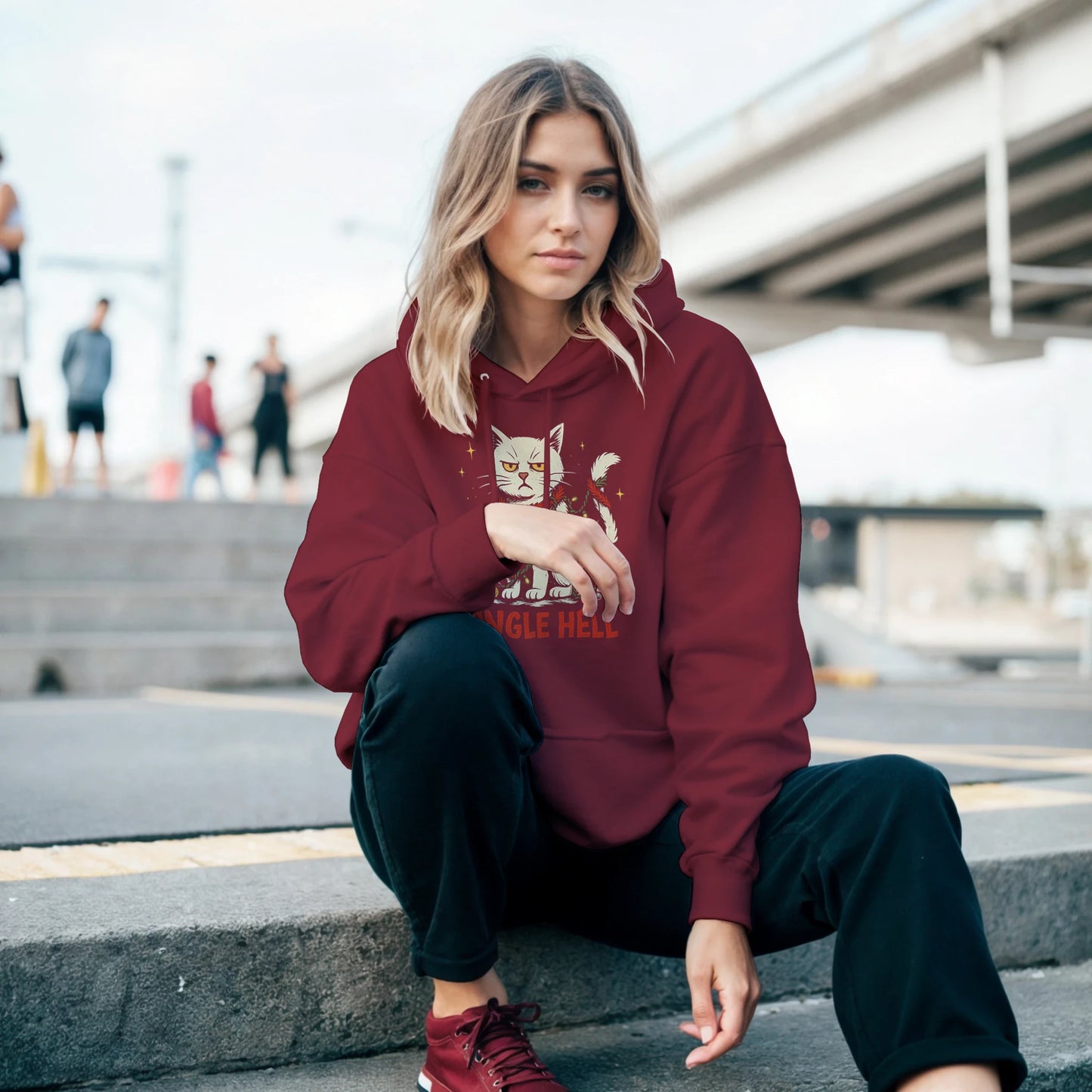 Person wearing the red Jingle Hell hoodie, showing relaxed fit and casual streetwear holiday style.