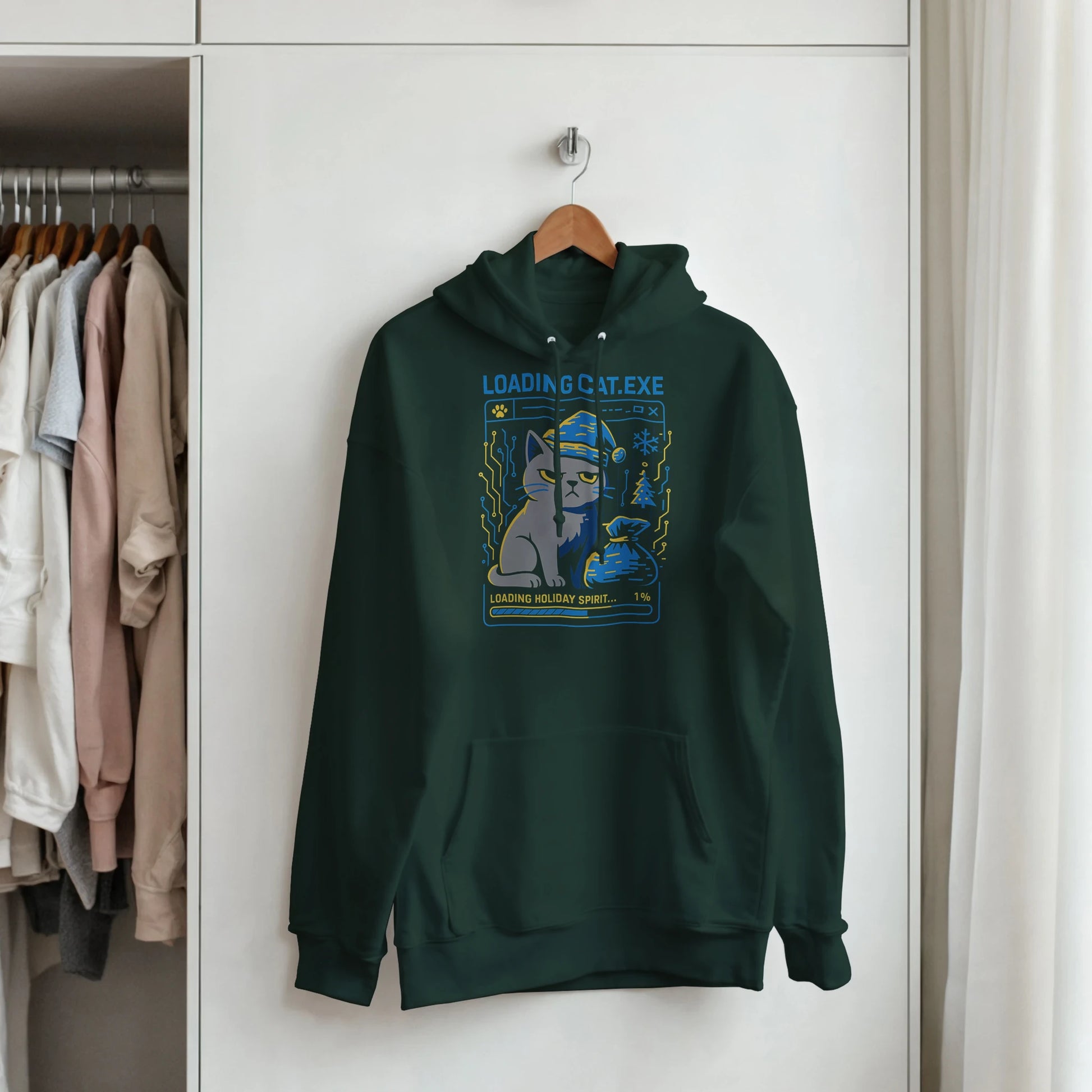 Green Merry Loading CAT.exe hoodie hanging on a rack. Streetwear holiday hoodie with glitch cat graphic.